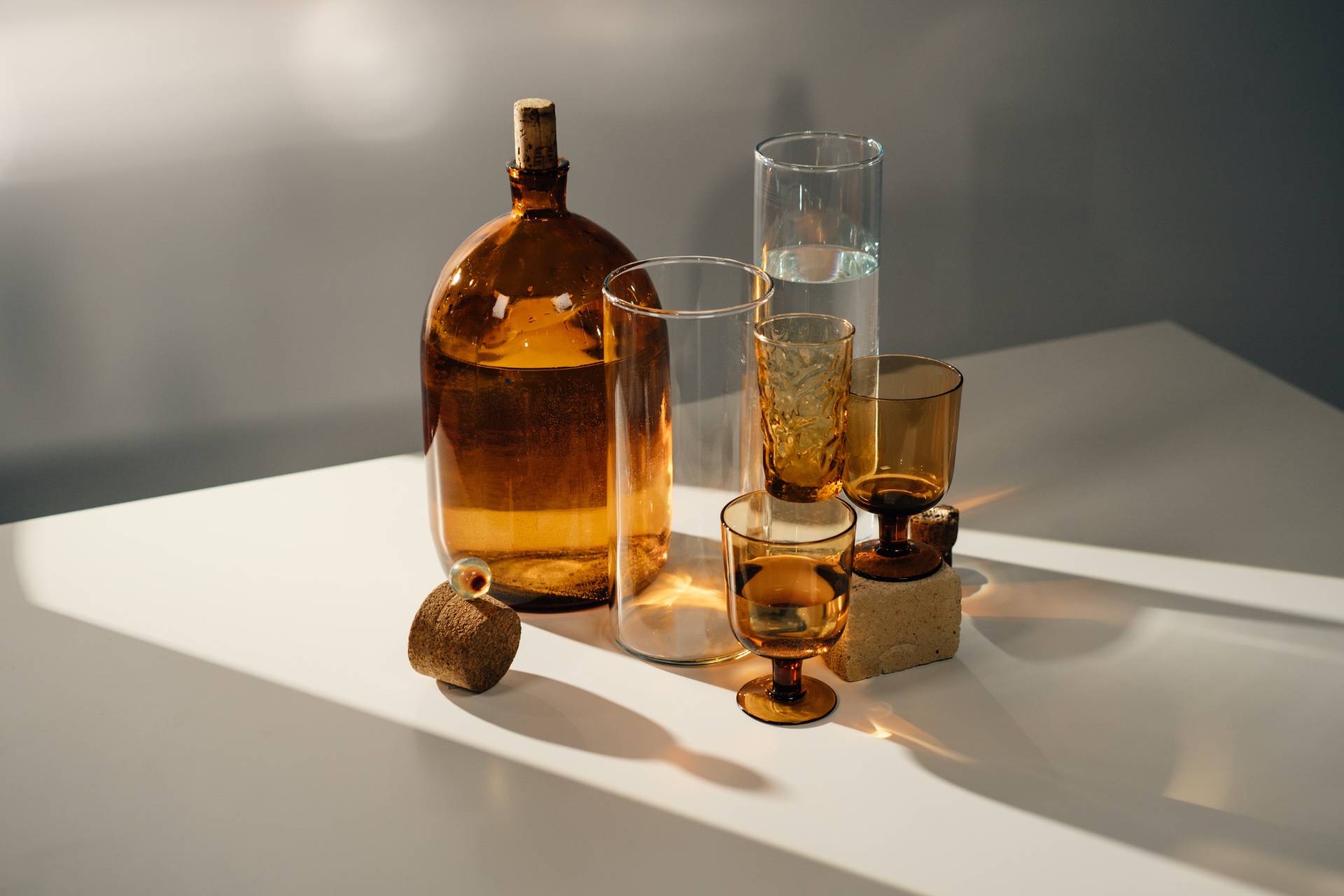 Amber glass bottle and glasses arranged on a table