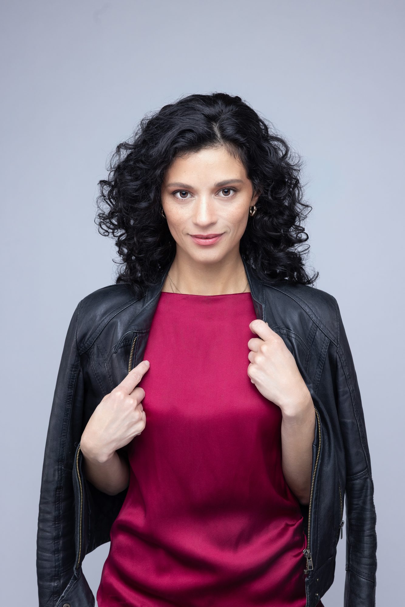 Editorial actor headshot of Natalie in a black leather jacket over a burgundy satin top, Ashland Oregon