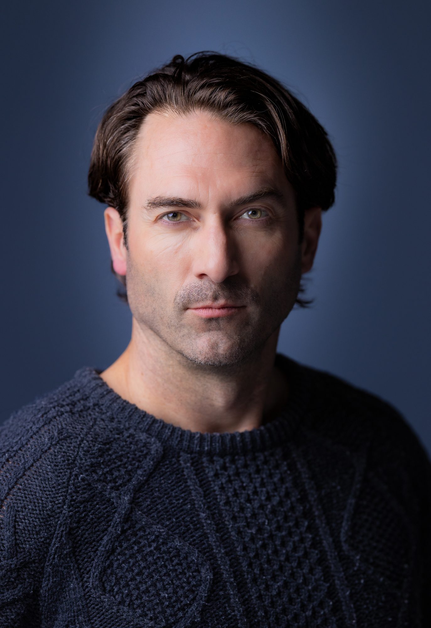 Actor headshot of Ryon Lane in a dark sweater with a serious, direct close-up gaze, Ashland Oregon
