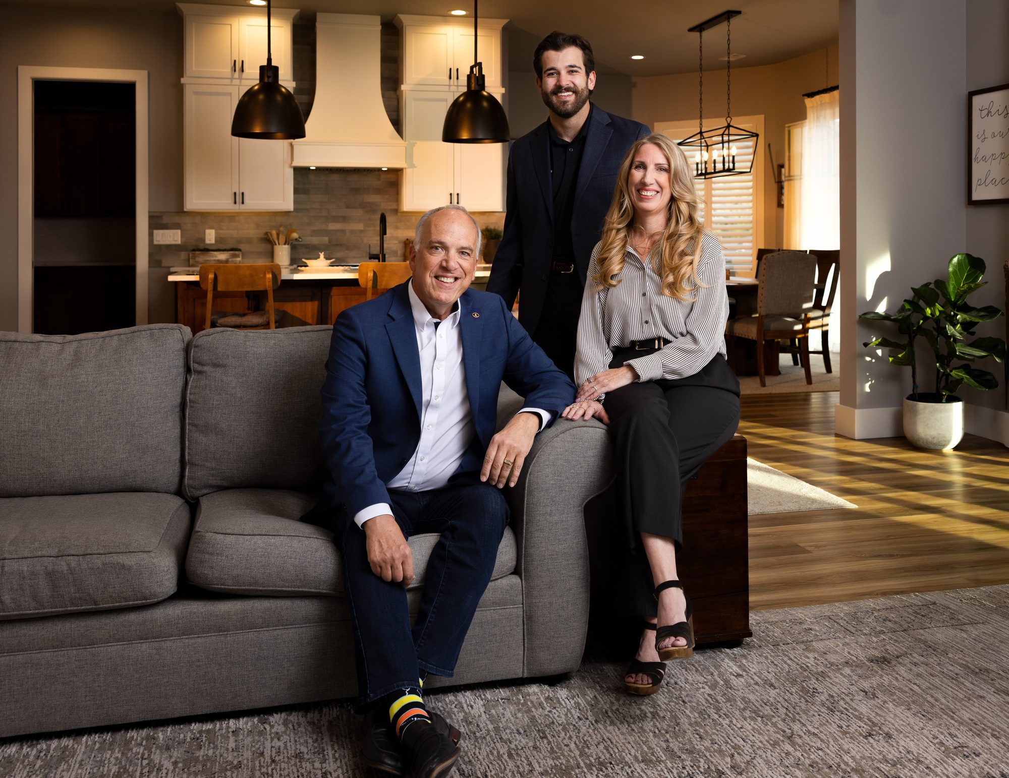 Real estate team portrait of the Scott Lewis Group staged in a client property's living room as their working environment, Ashland Oregon