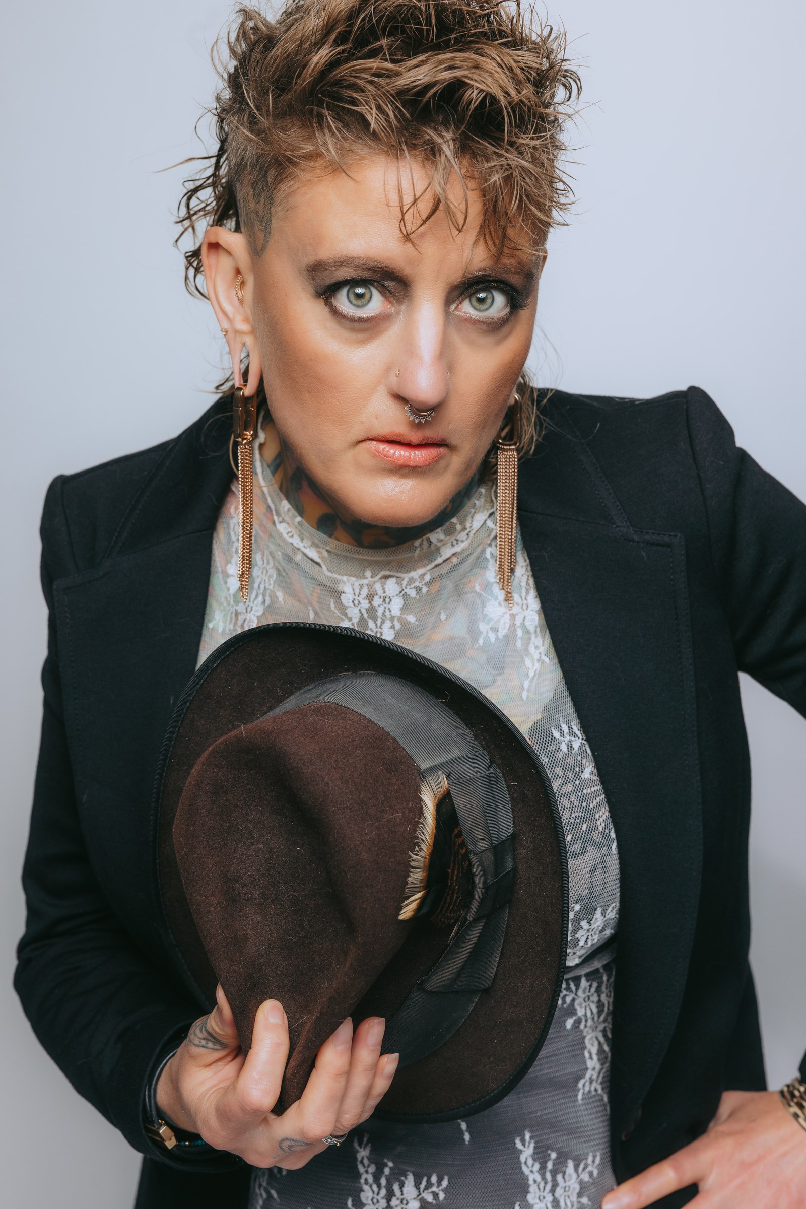 Chari in a fedora and tailored blazer, editorial portrait