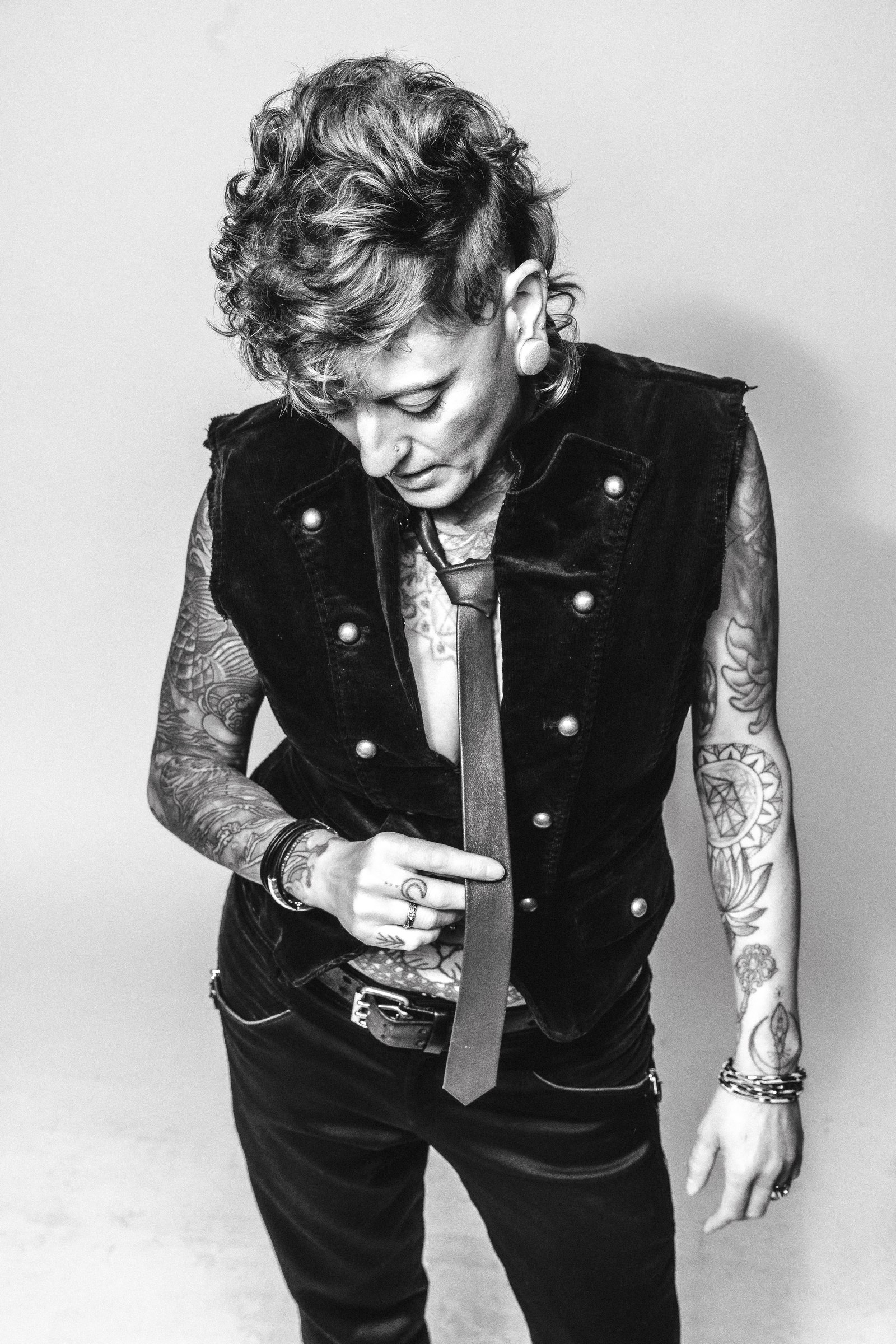 Black and white portrait of Chari in a tailored vest and tie