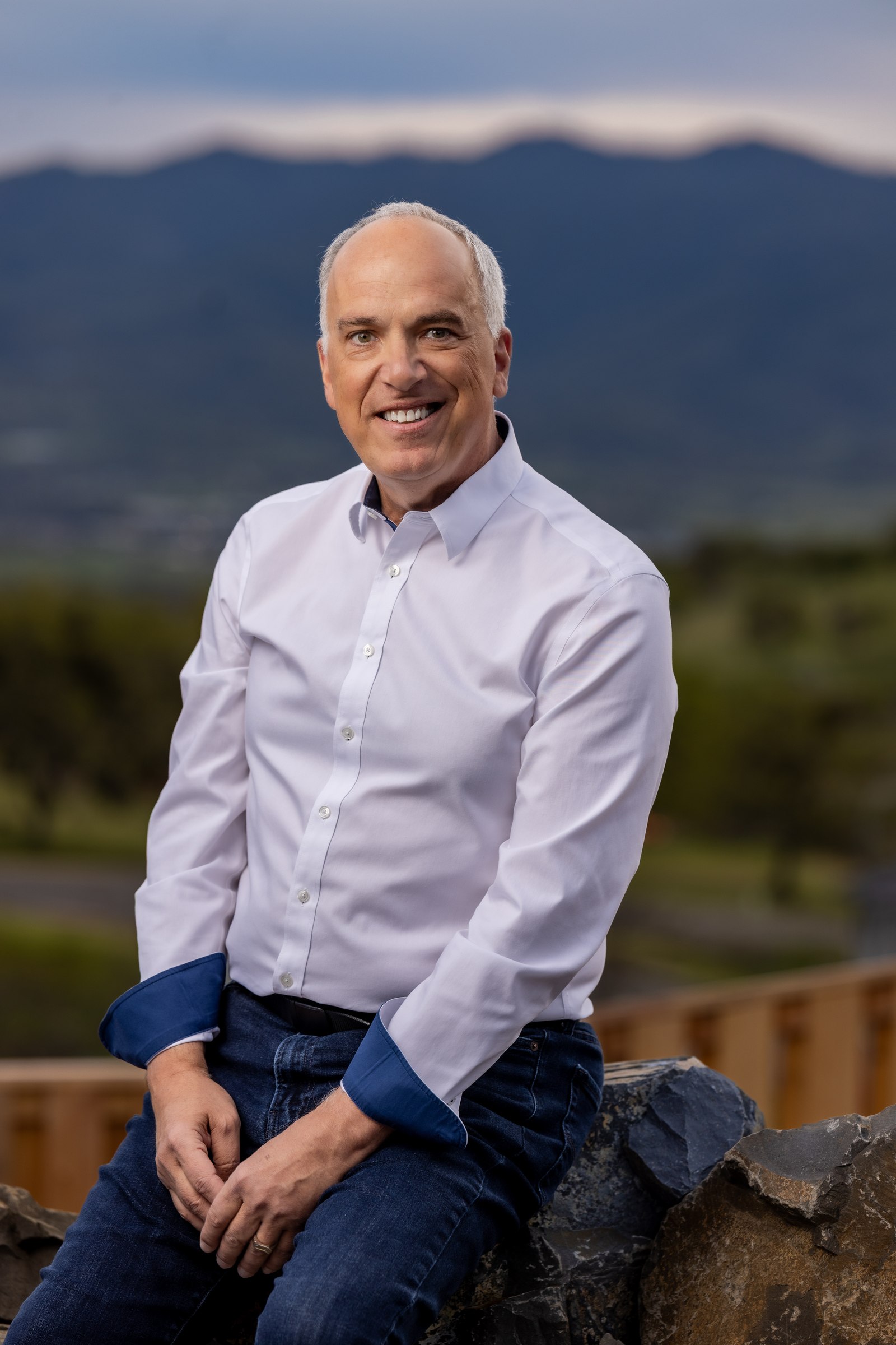 Scott Lewis, outdoor environmental portrait with mountain backdrop