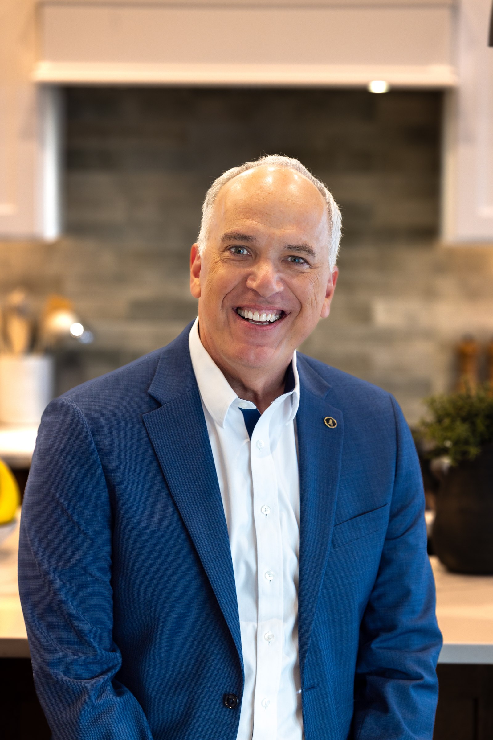 Scott Lewis, professional indoor headshot in a tailored blazer