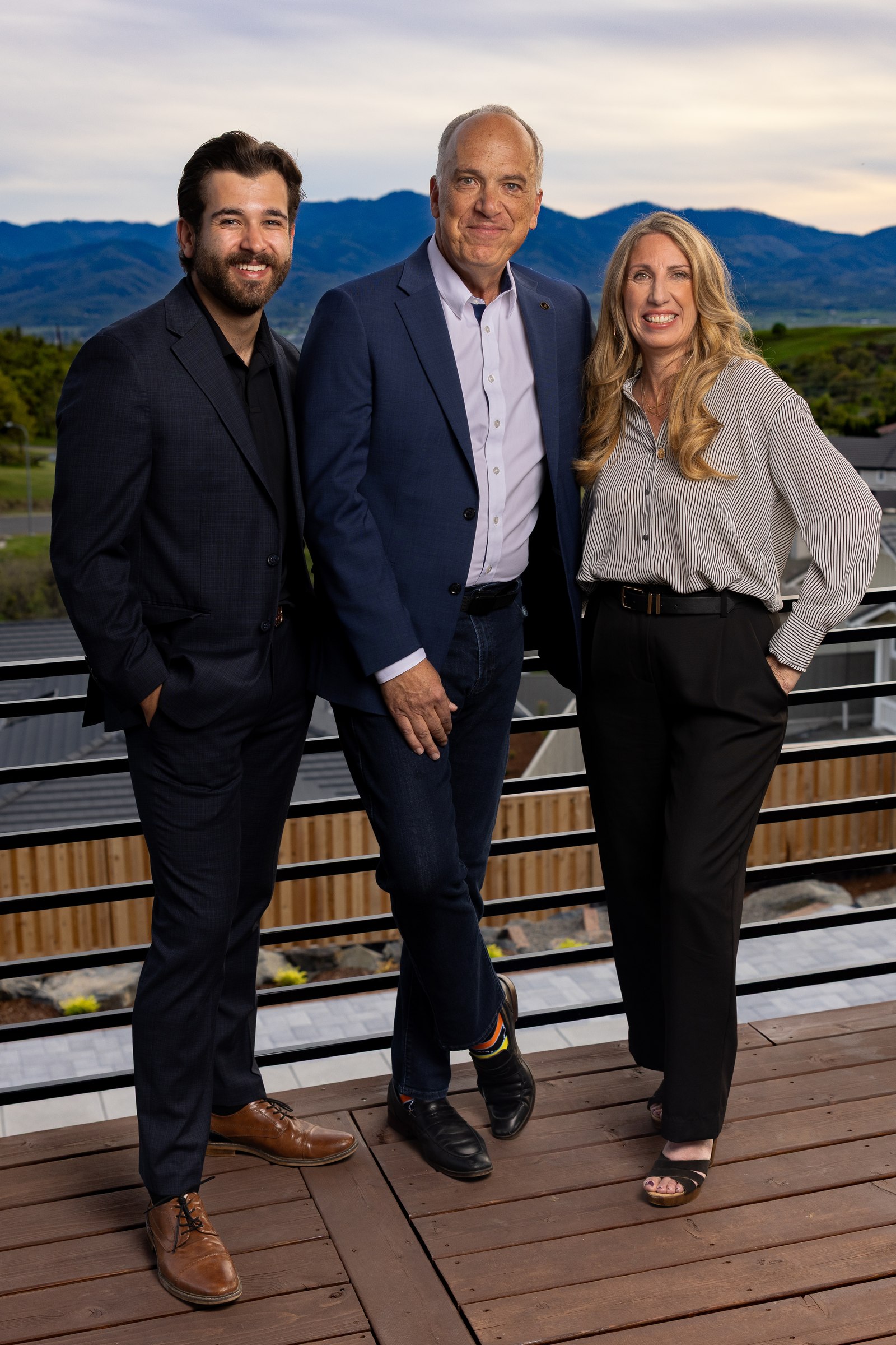 Scott Lewis Group team portrait on a rooftop deck with mountain views
