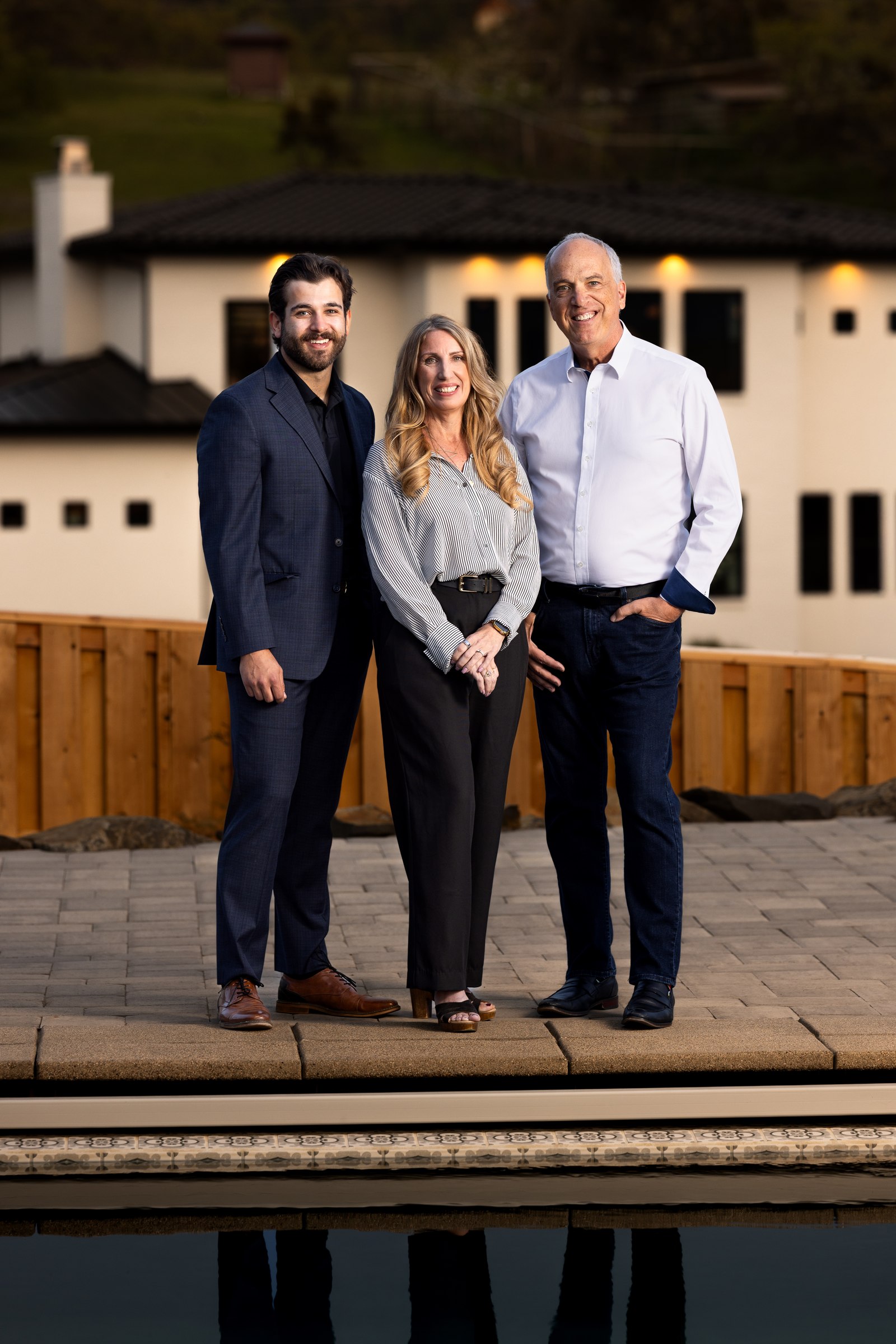 Scott Lewis Group team portrait at dusk beside a reflecting pool
