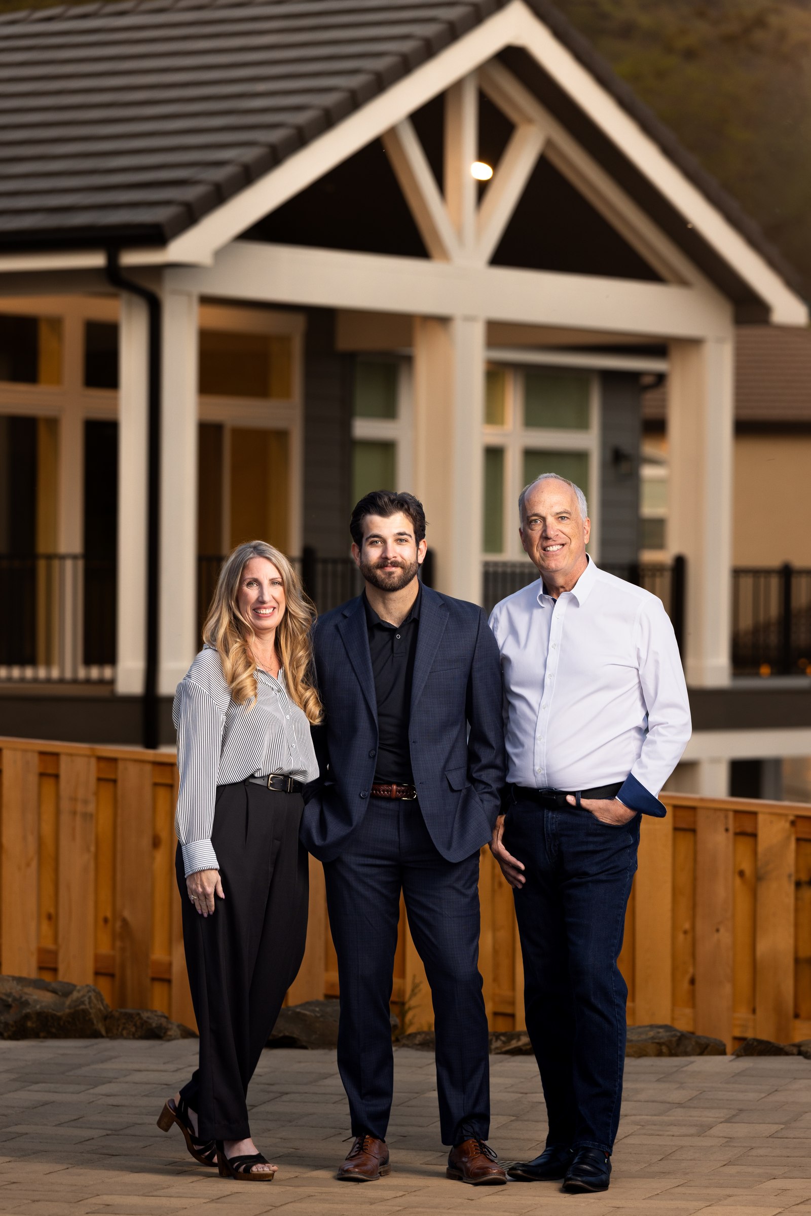 Scott Lewis Group team portrait at dusk on a covered porch